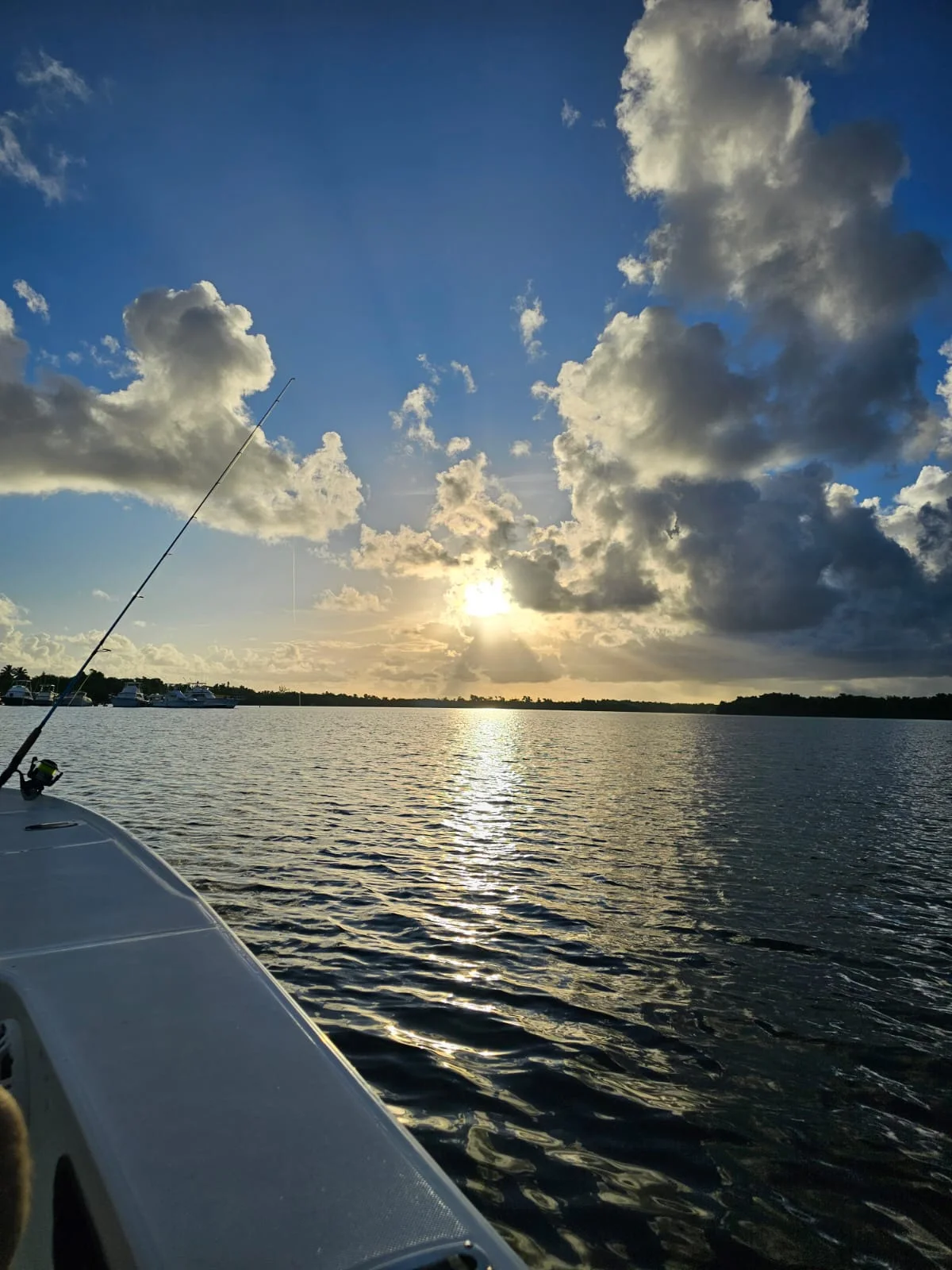 Rod silhouetted against the sunset over the lagoon